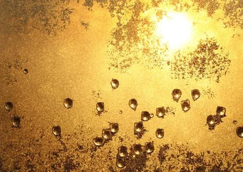 Ice and sun texture the droplets and the sunlight on a window pane Copyrig... Stock Photos