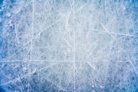 Ice background with marks from skating and hockey, blue texture of rink surface Stock Photos