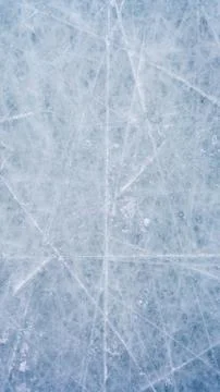 Ice background with marks from skating and hockey, blue texture of rink surface Stock Photos