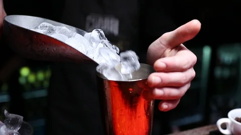 Ice being poured in to shaker Stock Footage 102009340