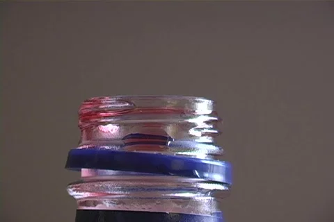 Ice blends with a ruby red liquid. Stock Footage 340153