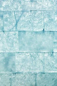 Ice block wall as texture or background. Cold frost transparent bricks pattern Stock Photos