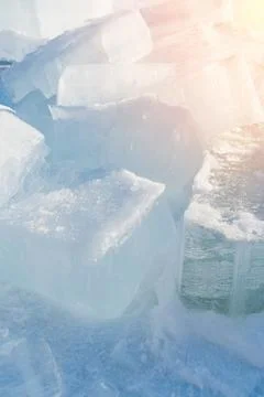 Ice blocks lying on the snow. Selective focus Stock Photos