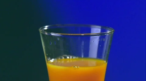Ice boxes falling into the juice. Stock Footage 591894