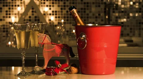 Ice bucket with bottle of wine, two wineglasses and a toy horse. Stock Footage 42820215