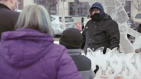 Ice carver interacting with crowd at winter festival in Carmel Indiana Stock Footage 153439535