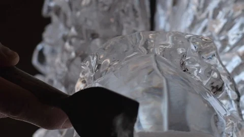 Ice carver sculpting eagle head ice sculpture with chisel Stock Footage 128387004