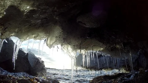 Ice cave on the water under the bridge in Eyrarbakki Iceland Stock Footage 118276748