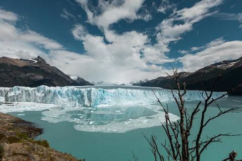 Ice chunks from the edge of Perito Moreno Glacier are calving into the lake Stock Photos