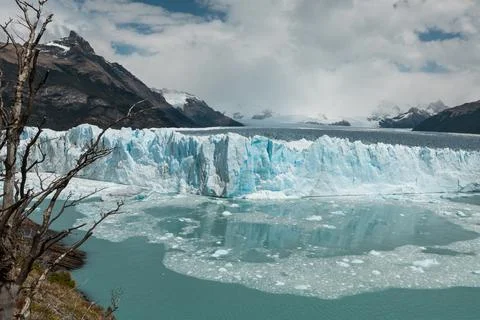 Ice chunks from the edge of Perito Moreno Glacier are calving into the lake Stock Photos