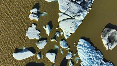 Ice chunks float in glacier lagoon, Blue icebergs forming from melting glacier 스톡 동영상 245284869
