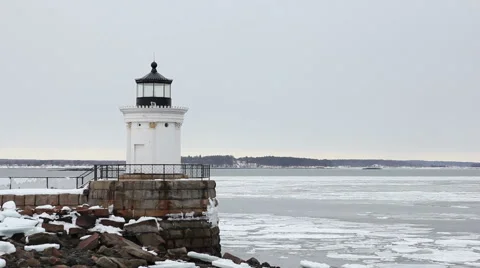 Ice chunks float past Bug Lighthouse, medium shot, South Portland Maine Stock Footage 47086009