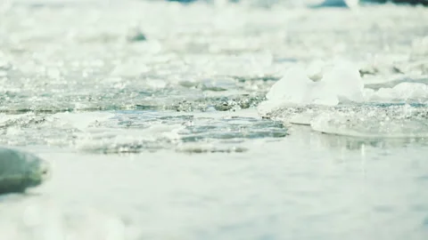 Ice chunks floating on water close up in Iceland Stock-Footage 348026635