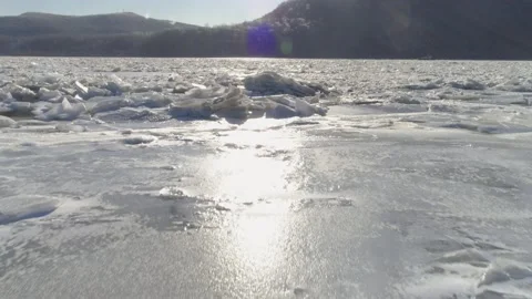 Ice Chunks on Frozen River w/ Colorful Lens Flare-Hudson Valley New York Aerial Stock Footage 170519347