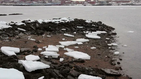 Ice chunks sit on beach as snow starts to fall, Portland Maine Stock Footage 47087816