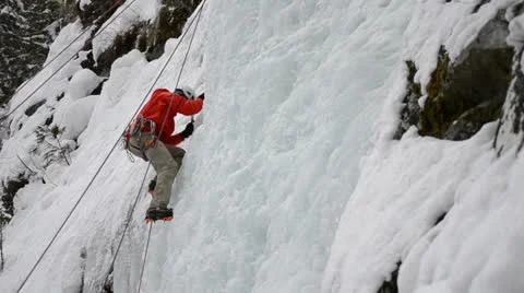 Ice climber frozen waterfall Stock Footage