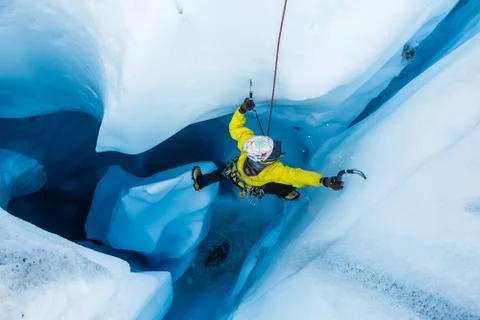 Ice climber on piller inside vertical ice cave on the Matanuska Glacier. Stock Photos