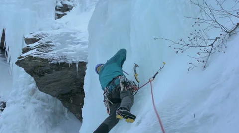 Ice climber placing protection Stock Footage 47313828