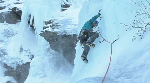 Ice climber on steep waterfall winter Stock Footage 47314106