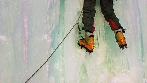 Ice Climber, Young man with ice axes and crampons training to climb  Видео 70553751