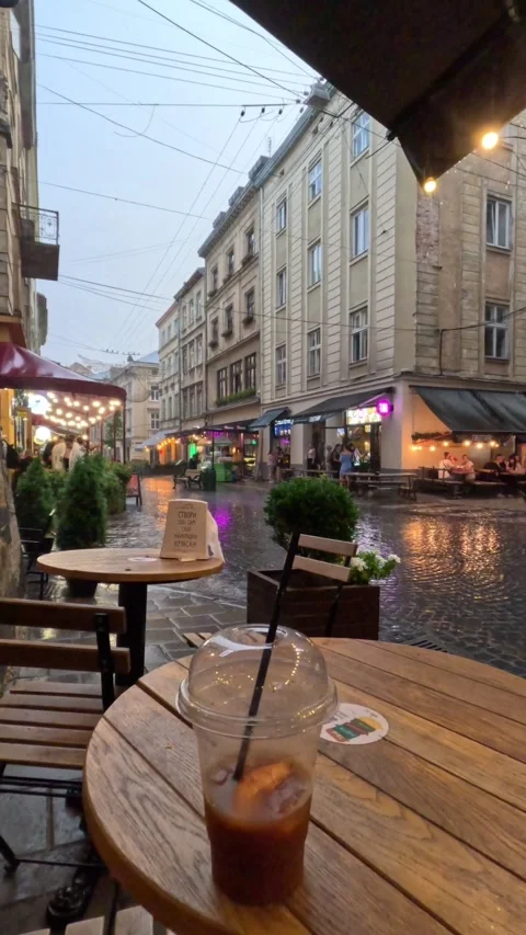 Ice coffee mug on the table in cafe rain outside Stock Footage 249990511