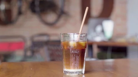 Ice coffee on a wooden table Stock Footage 92201930