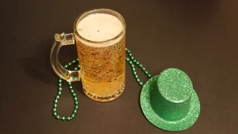 Ice Cold Beer in Beer Mug on Table with Green Irish Hat St. Patrick’s Day Stock Footage 125194388