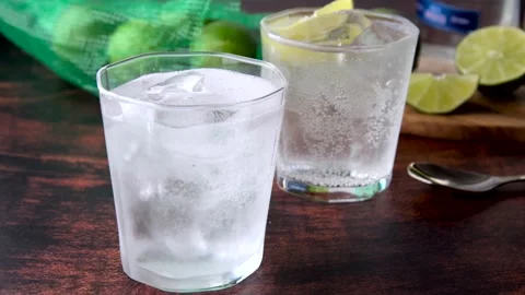 Ice cold gin tonic image on wooden background	 Stock Footage 143429754
