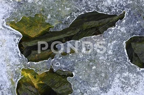 Ice on colourful stones Stock Photos