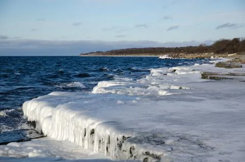 Ice covered flat rock coast Stock Photos
