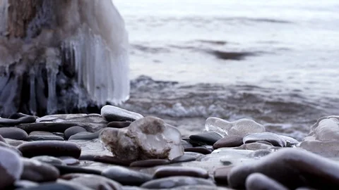 Ice covered rocks and tree stump at Lake Superior in winter Michigan 4K Stock Footage 100451911