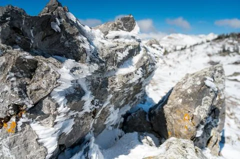 Ice covered rocks showing the wind direction blowing in the mountain. Stock Photos