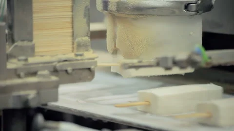 Ice cream bars close up. Old machine lifting frozen popsicles from metal mold. Stock Footage 347538181