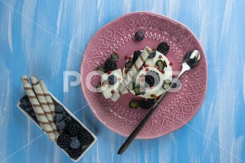 Ice cream with blueberries, blackberries and confectionery. a refreshing dess Stock Photos