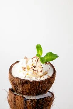 Ice cream in coconut shell on white background Stock Photos