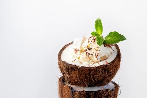 Ice cream in coconut shell on white background Stock Photos
