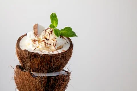 Ice cream in coconut shell on white background Stock Photos