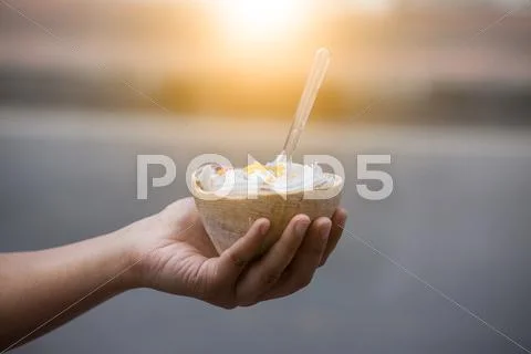 Ice Cream In Coconut Shell With Woman Hand