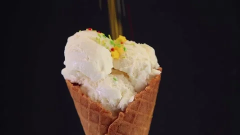 Ice cream cone on a black background is decorated Stock Footage 163090214