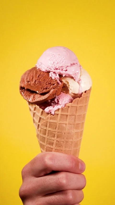 Ice Cream Cone With Multiple Flavors Held by a Hand Stock Footage 270044032