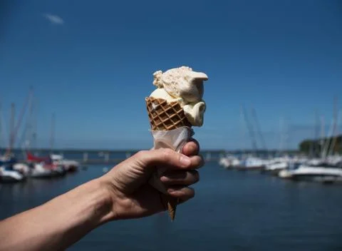 Ice cream cones hold up to the hot summer sky Stock Photos