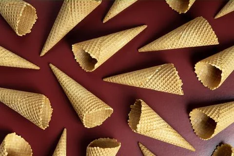 Ice cream cones pattern. Brown background. Sweet, summer and empty concept. Stock Photos