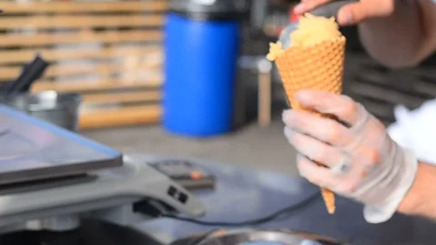 Ice cream containers with customer hands view Stock Footage 96987735