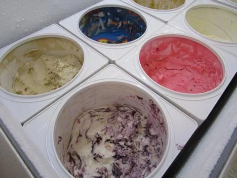 Ice Cream containers in serving case Stock Photos