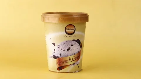Ice cream containers on yellow , Stock Footage 187707277