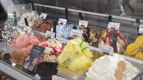 Ice cream kiosk layout behing showcase glass on touristic street in Athens Stock Footage 272225011