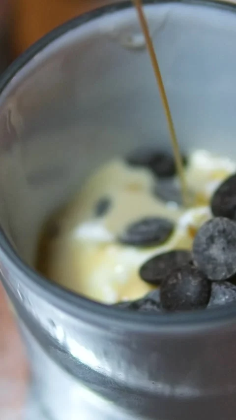 Ice cream maker mixing pine nuts milk liqueur dark chocolate slices and alcohol Stock Footage 318728309
