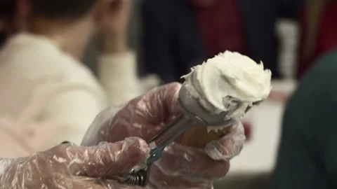 Ice cream making. A special spoon is placed in a waffle cone. Stock Footage 130239805