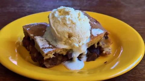 Ice cream melting on warm apple pie tart Stock Footage 334075603