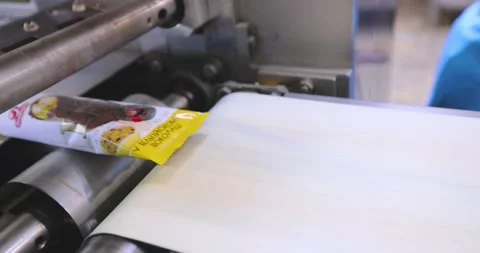 Ice cream packaging process. Ice cream packaging in cellophane.Automatic Stock Footage 238759542